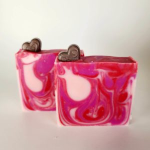 A picture of a red and pink swirled Valentine's soap with a brown heart imbedded in the top of the soap.