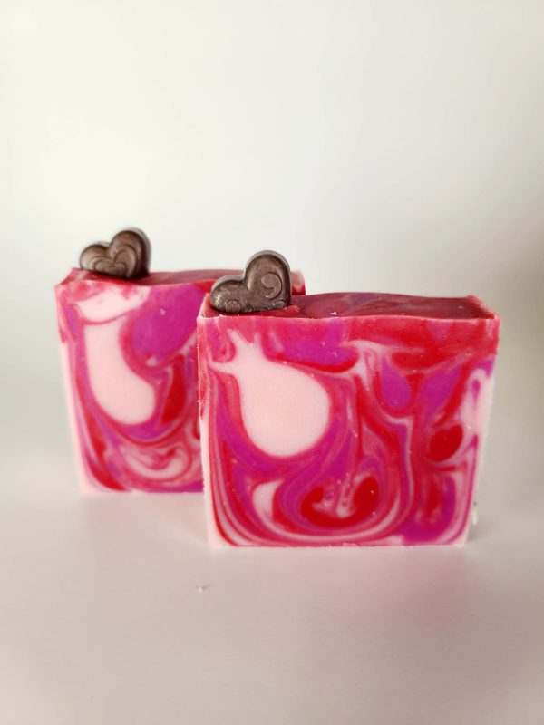 A picture of a red and pink swirled Valentine's soap with a brown heart imbedded in the top of the soap.