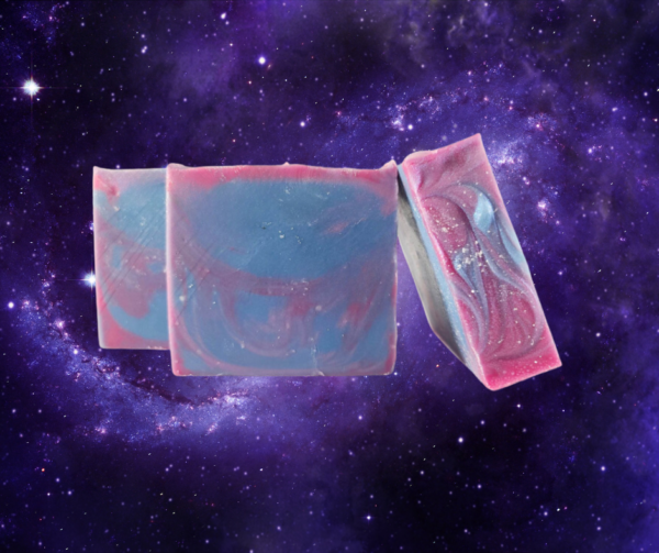 A trio of blue, red, and purple swirled soaps floating in an outer space background.