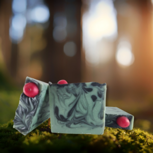 Three gren soaps with black swirls and a red soap imbed in the shape of an apple on top.