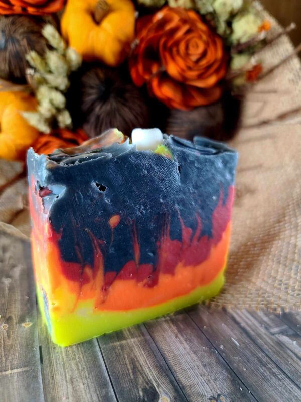 A Black, orange, and red swirled soap designed to resemble the flame of a bonfire. Complete with a marshmallow soap imbed on top.