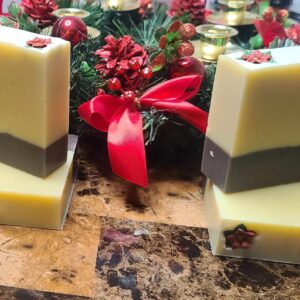 A picture of a brown and cream layered soap in front of a Christmas decoration.