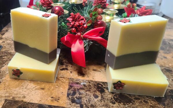 A picture of a brown and cream layered soap in front of a Christmas decoration.