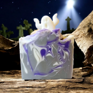 A Grey, white, and purple swirled soap with a ghostly soap embed on top.