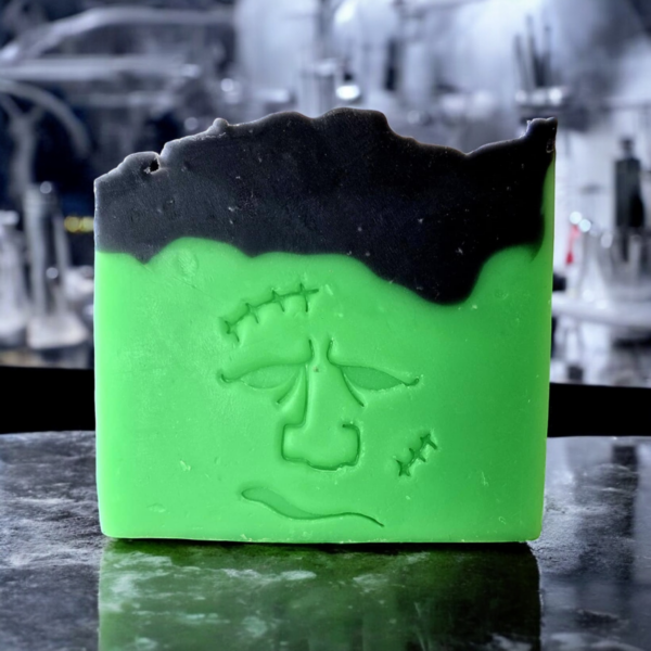 A green and black soap with a stamp of Frankenstein's face on it.